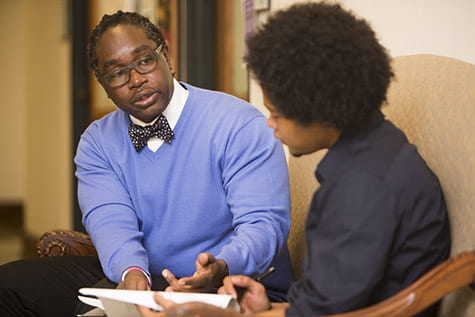 Sean Joe, PhD, the Benjamin E. Youngdahl Professor in Social Development, talks with Brown School doctoral student Andrae Banks in Brown Hall. Joe is a leading national authority on suicide among black Americans.